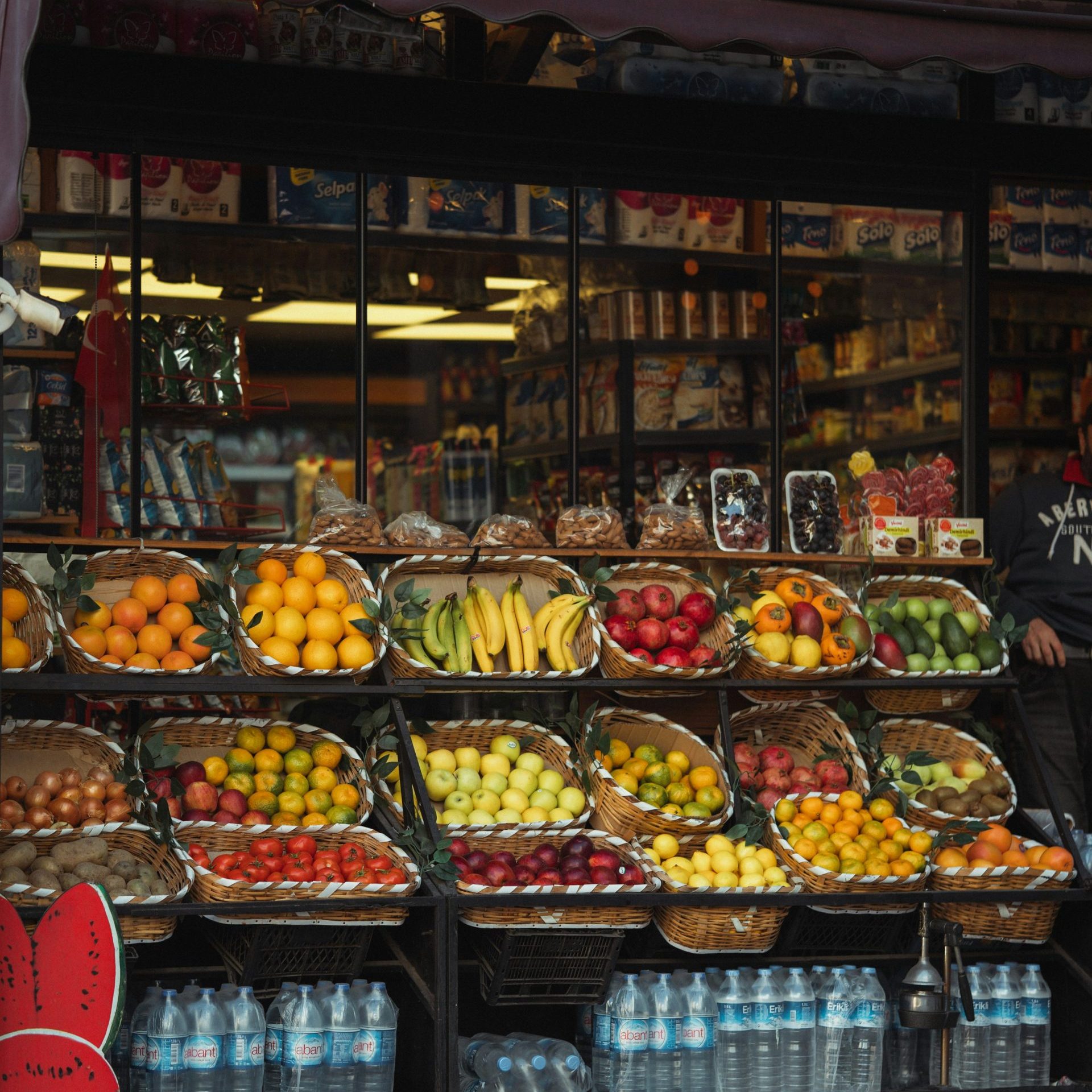a fruit stand with fruits and drinks